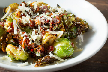 A closeup view of a plate of Brussels sprouts.