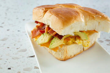 A view of a breakfast sandwich on a Hawaiian roll.