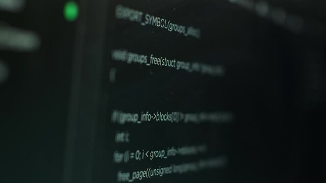 Extreme close up shot of hacking code running on computer system monitors attacking firewalls. Programming scripts shown on PC screen used by cyber criminals to breach security