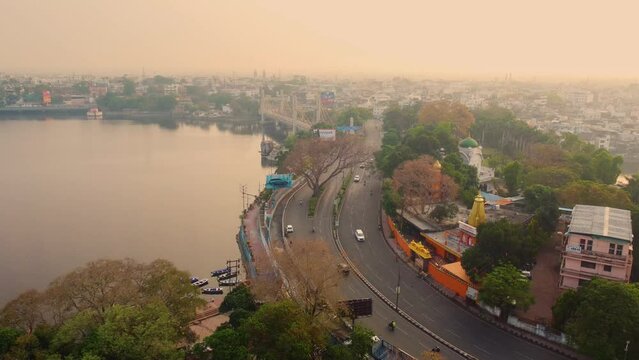 Aerial drone shot of bhopal capital city of madhya pradesh with upper lake and downtown roads with car traffic in india