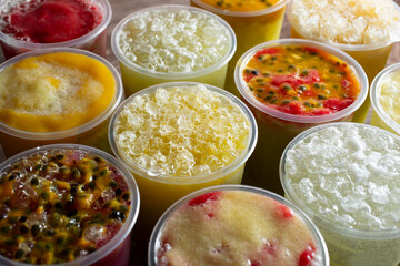 A closeup view of several flavored sugarcane juice drinks.