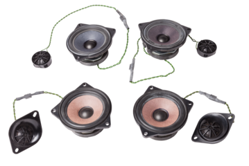 speakers of an acoustic system - an audio for playing music in a car interior on a white isolated background in a photo studio. Spare parts for auto repair in a workshop or for sale for tuning