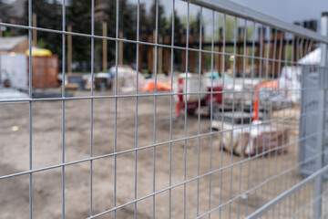 Construction site behind chain link wire fence in Calgary