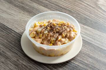 A view of a container of esquites.