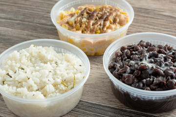 A view of Mexican side dishes, featuring cilantro rice, black beans and esquites.