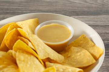 A view of a bowl of tortilla chips and vegan nacho cheese.
