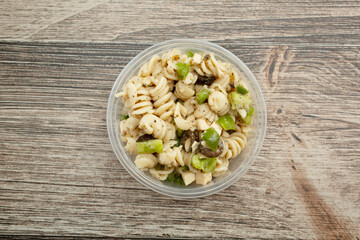 A top down view of a container of pasta salad.