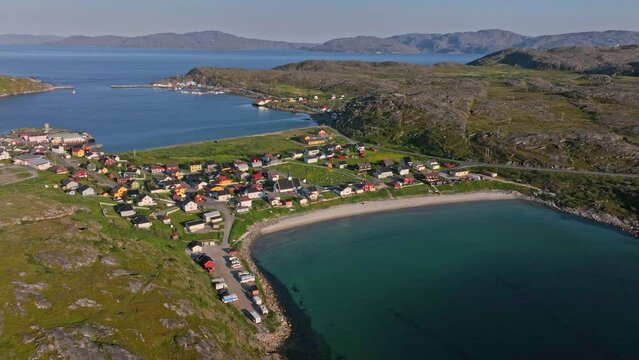 Vestersanden beach and the Bogoynes town, sunset in north Norway - Aerial tracking shot
