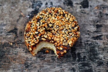 Donuts with peanut and chocolate topping on top close up.