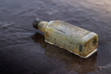 Decomposed Glass bottle at the beach. Ocean Pollution concept.