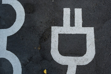 The symbol for charging the electric vehicle (EV)on parking spot. Charging station