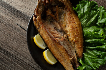 A top down view of a plate of grilled Atka mackerel.