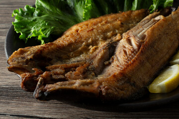 A closeup view of a plate of grilled Atka mackerel.