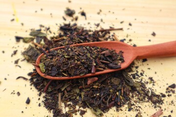 Dry green tea stacked and some scattered with close view.