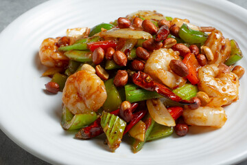 A closeup view of a plate of kung pao shrimp.
