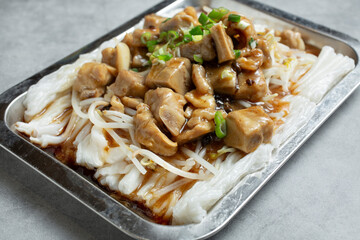 A view of a tray of rice rolls, featuring pork rib meat.