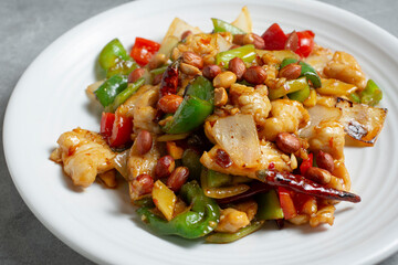 A closeup view of a plate of kung pao chicken.