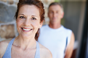 Fitness, happy and portrait of mature couple outdoor on brick wall for running or training together. Cardio, exercise and smile with face of woman at start of workout routine to improve health