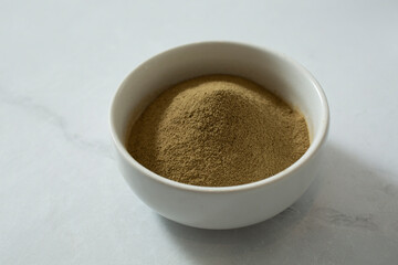 A view of a condiment cup of seaweed extract powder.