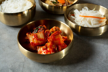 A view of a variety of banchan dishes, featuring kimchi.
