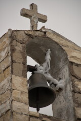 Steeple of medieval stone church against sky