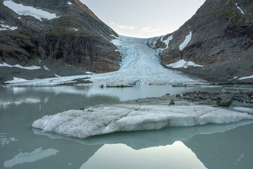 The melting Steindalsbreen Glacier and glacial lake it feds on a blue evening moment, Lyngen Alps,...