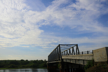 clouds with Calm weather over the water. Ocean with clouds on a background of green trees and blue sky