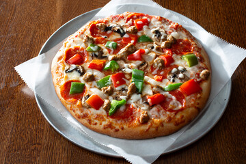 A view of a deluxe personal pizza.