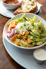 A view of a bowl of pasta salad.