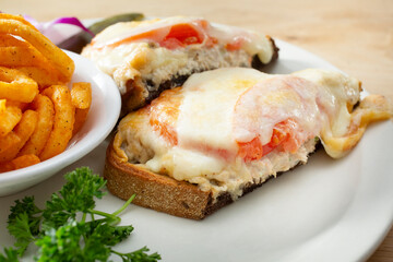 A view of an open faced tuna melt sandwich.