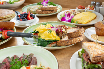 A view of a variety of breakfast and brunch food items on a table.