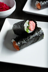 A view of a hand roll, featuring fatty tuna.