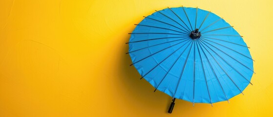 Blue umbrella with blank copyspace on yellow background