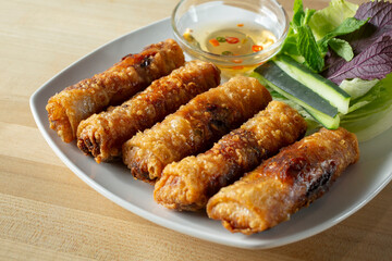 A view of a plate of Vietnamese egg rolls.