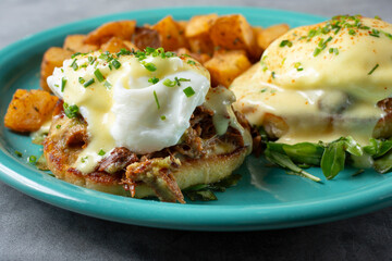 A closeup view of a plate of short ribs eggs Benedict.