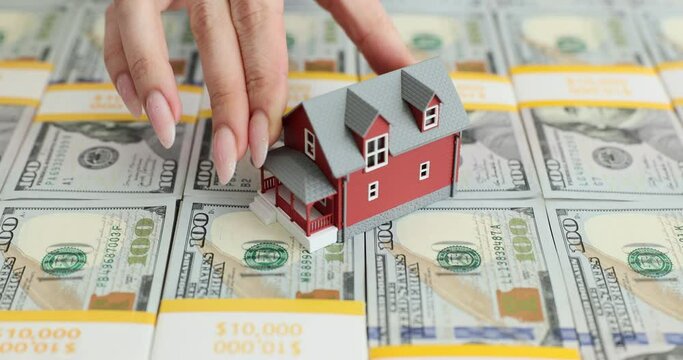 Mockup of a red house on a large stack of 100 bills