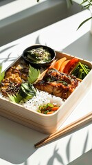 A minimalist setup featuring a bento box containing rice, pickles, grilled fish, and fresh vegetables on a clean white table with bright, indirect lighting