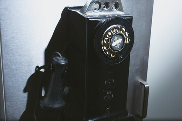 A view of a vintage rotary public telephone.