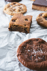 A view of a several cookie treats, featuring a chocolate chip cookie brownie.