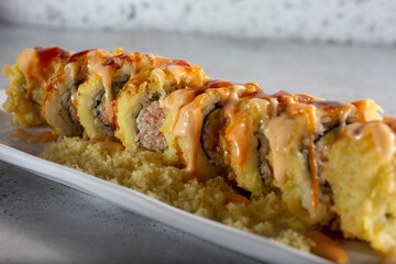 A closeup view of a tempura California roll. © DAVID