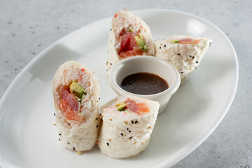 A view of a plate of sushi featuring white soy wrappers. © DAVID