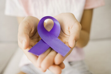 Hands holding purple ribbon, Alzheimer's disease, Pancreatic cancer, Epilepsy awareness, world...