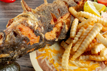 A top down view of a plate of deep fried catfish.