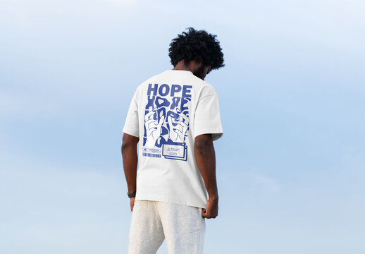 Mockup of man wearing customizable t-shirt, rear view