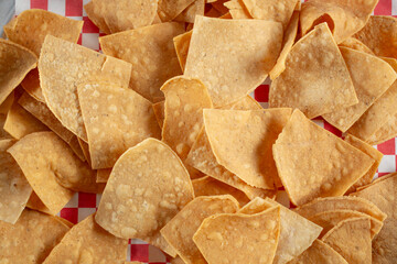 A top down view of a pile of corn tortilla chips.