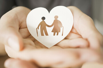 Hands holding elderly couple with walking sticks in heart shape, older people mental health, age...