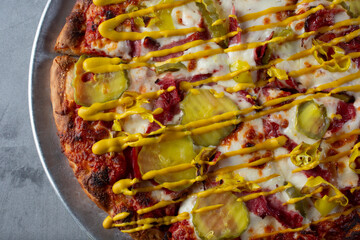 A top down view of a pastrami pizza.