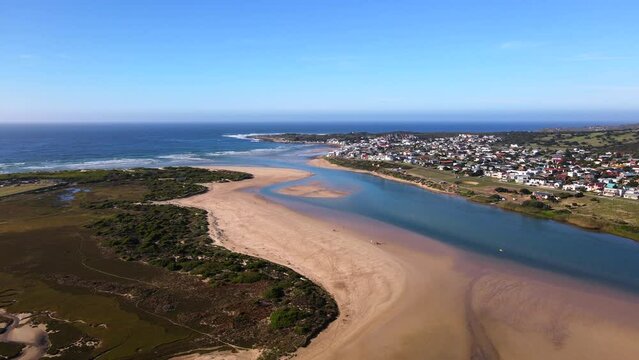 Sweeping drone pan view over Goukou river estuary mouth, Still Bay South Africa