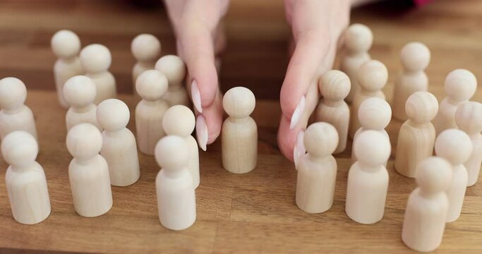 Wooden figures of people gathered together to form crowd