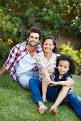 Smile, nature and portrait of kid with parents in park bonding together on outdoor family vacation. Happy, love and boy child with mother and father relax on grass in garden for countryside holiday.